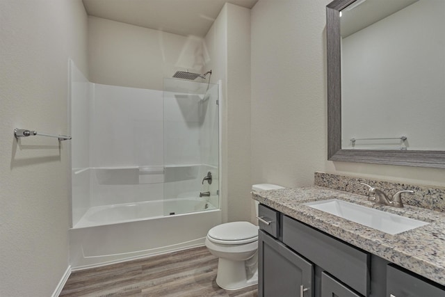 full bath with tub / shower combination, toilet, vanity, and wood finished floors