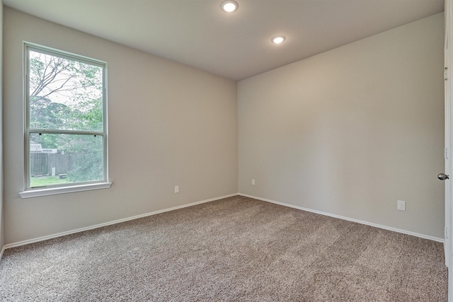 empty room featuring recessed lighting, carpet, and baseboards