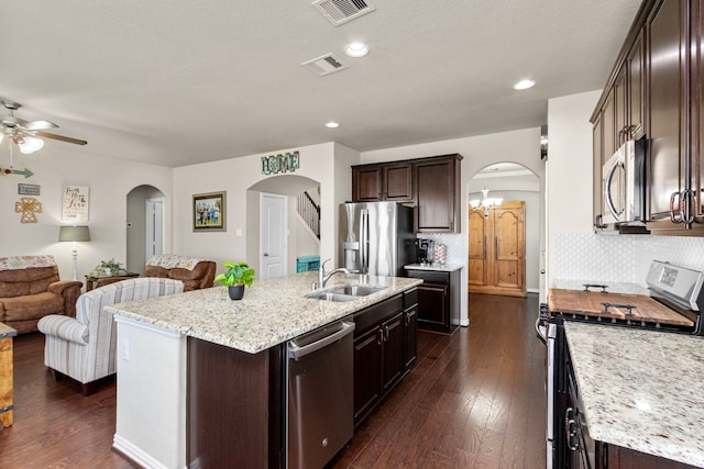 kitchen featuring visible vents, appliances with stainless steel finishes, arched walkways, and a sink