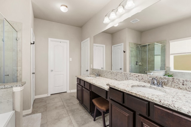 full bath featuring double vanity, a stall shower, a sink, and visible vents