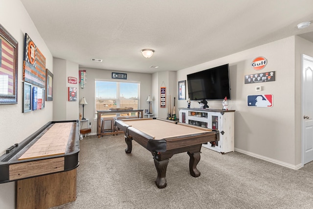 recreation room with baseboards, a textured ceiling, visible vents, and carpet flooring