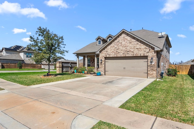 view of front facade featuring a garage, driveway, fence, a front yard, and brick siding