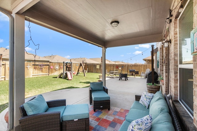 view of patio / terrace featuring a playground, an outdoor living space, and a fenced backyard