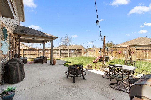 view of patio / terrace with outdoor dining space, a fenced backyard, area for grilling, and an outdoor living space with a fire pit