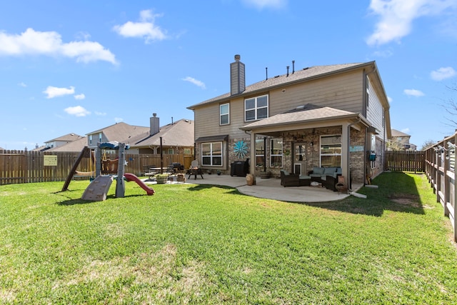 rear view of property featuring brick siding, a patio, a playground, a lawn, and a fenced backyard