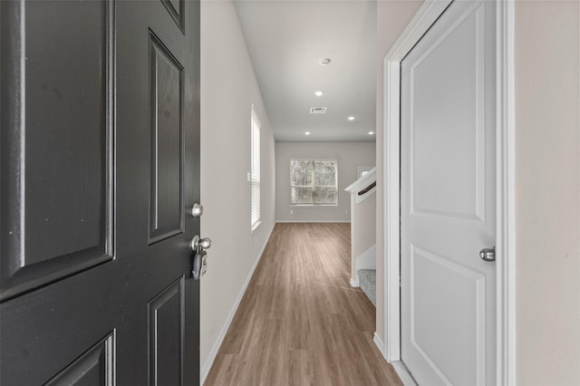 foyer entrance featuring light wood-style flooring, recessed lighting, visible vents, baseboards, and stairway