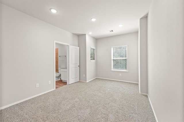 unfurnished room featuring visible vents, baseboards, carpet flooring, and recessed lighting