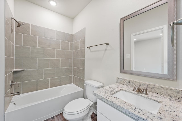 bathroom with shower / tub combination, vanity, and toilet