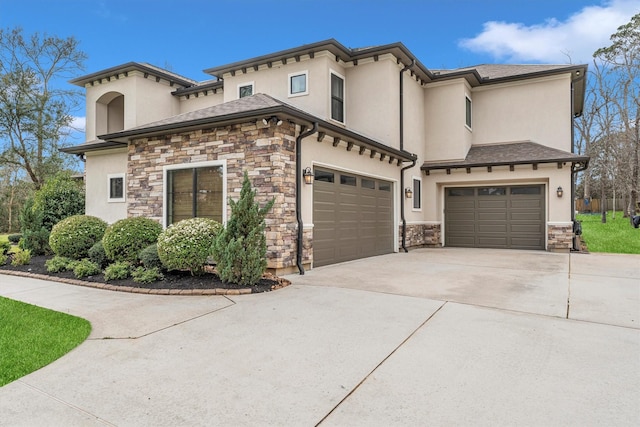 view of front of house with stone siding, an attached garage, concrete driveway, and stucco siding