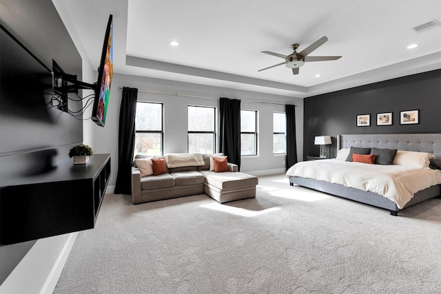 carpeted bedroom with recessed lighting, a raised ceiling, visible vents, ceiling fan, and baseboards