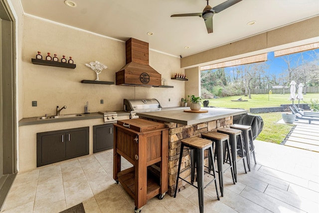 kitchen featuring crown molding, light tile patterned floors, open shelves, custom range hood, and a sink