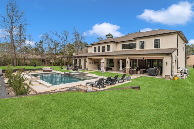 back of house featuring a yard, stucco siding, a pool with connected hot tub, an outdoor hangout area, and a patio area