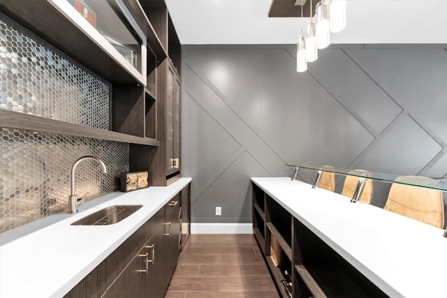 kitchen with open shelves, light countertops, decorative backsplash, a sink, and dark brown cabinets