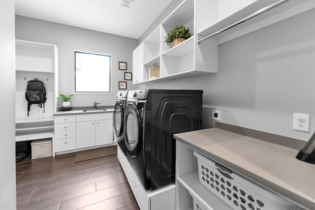 clothes washing area featuring cabinet space, visible vents, dark wood finished floors, separate washer and dryer, and a sink