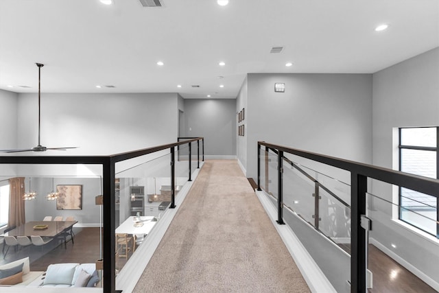 hallway featuring visible vents, baseboards, and recessed lighting