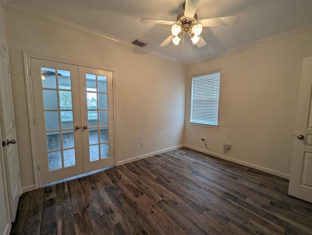 empty room featuring baseboards, ornamental molding, dark wood finished floors, and french doors