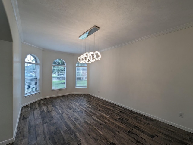 unfurnished dining area featuring dark wood-style floors, baseboards, crown molding, and an inviting chandelier