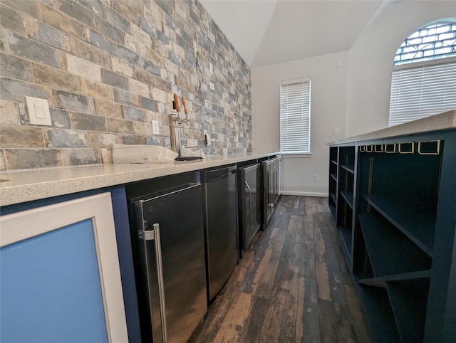 bar featuring lofted ceiling, dark wood-style floors, a dry bar, and refrigerator