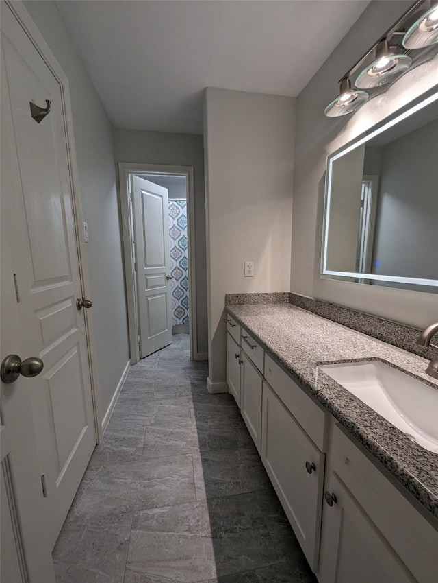 bathroom with vanity and baseboards