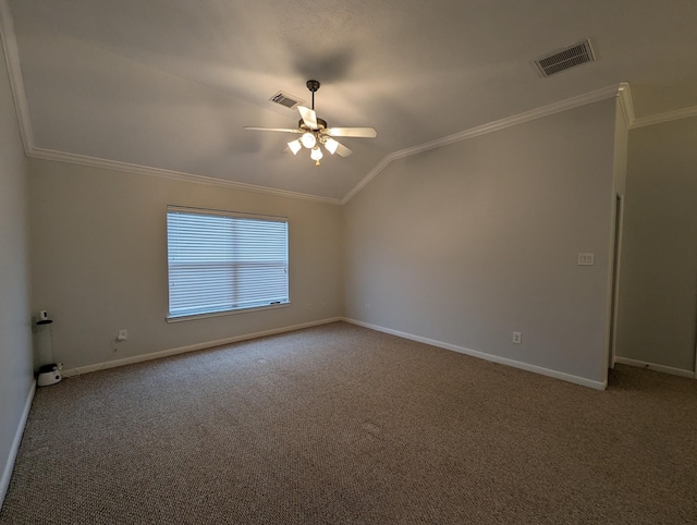 carpeted spare room featuring lofted ceiling, a ceiling fan, visible vents, and crown molding