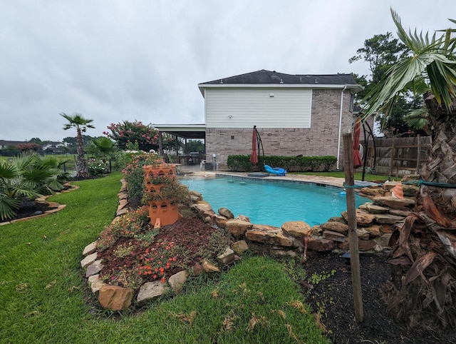 view of swimming pool featuring a fenced in pool, fence, a lawn, and a patio