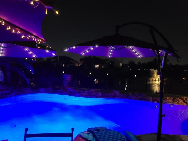 view of pool at night