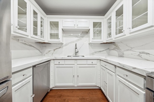 kitchen with dishwasher, white cabinetry, and a sink