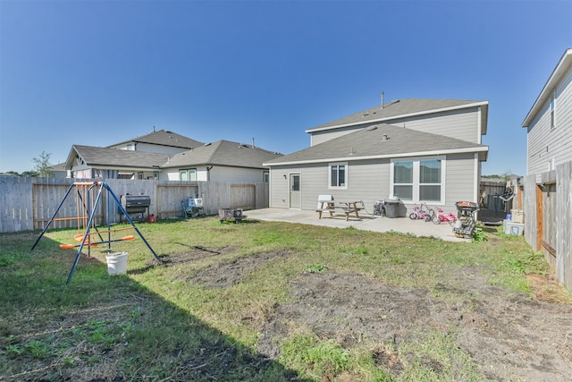 back of house with a patio area, a fenced backyard, and a yard