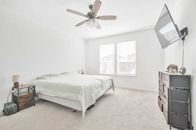 bedroom featuring baseboards, a ceiling fan, and light colored carpet