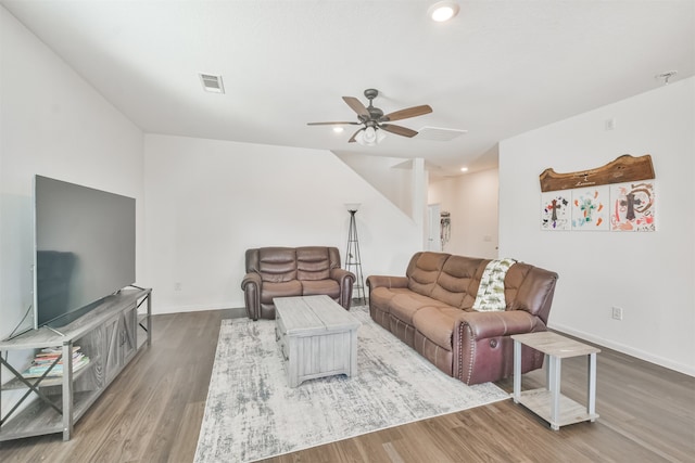 living room with ceiling fan, wood finished floors, visible vents, and baseboards