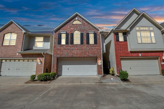 view of front of property with a garage, brick siding, and driveway