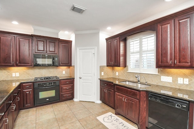 kitchen featuring visible vents, dark brown cabinets, black appliances, a sink, and light tile patterned flooring