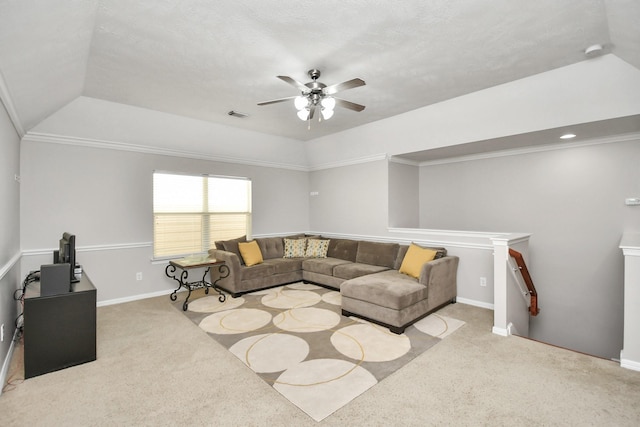 carpeted living room featuring baseboards, ornamental molding, visible vents, and a ceiling fan