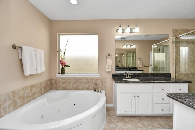 bathroom featuring tile patterned floors, a shower stall, a tub with jets, and vanity