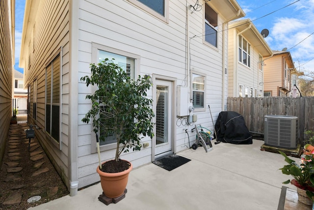 exterior space with central AC unit and fence