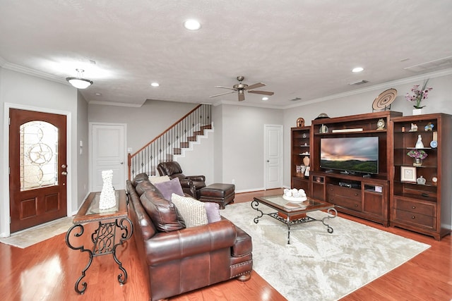 living area featuring recessed lighting, visible vents, stairway, ornamental molding, and wood finished floors