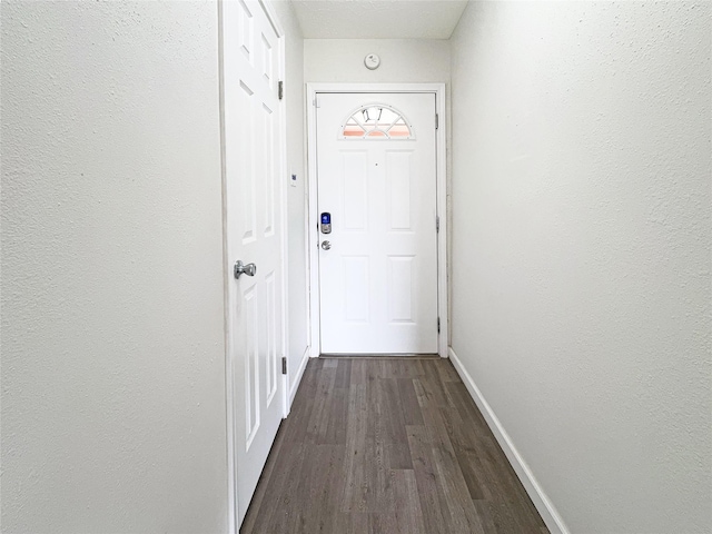 8611 Deep Valley Dr, Houston, TX 77044 - entryway featuring baseboards, dark wood-style flooring, and a textured wall