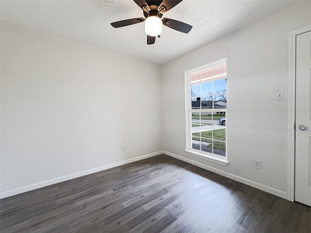 8611 Deep Valley Dr, Houston, TX 77044 - unfurnished room with a textured ceiling, baseboards, and dark wood-type flooring