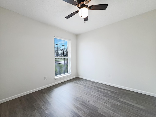 8611 Deep Valley Dr, Houston, TX 77044 - spare room with a ceiling fan, dark wood-style flooring, and baseboards
