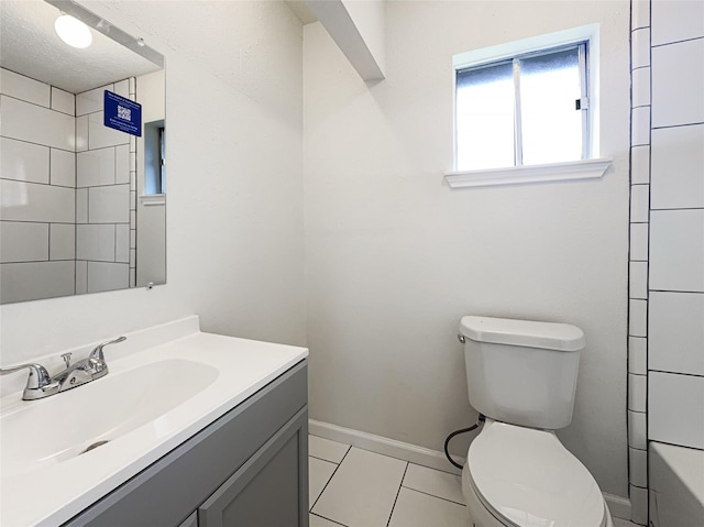 8611 Deep Valley Dr, Houston, TX 77044 - full bathroom with a shower, toilet, vanity, tile patterned flooring, and baseboards