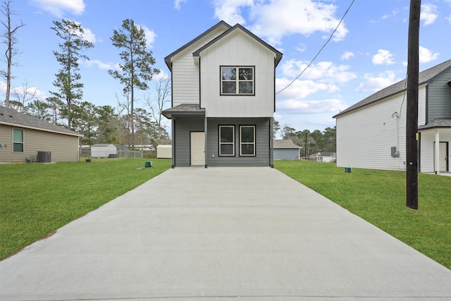 view of front of home featuring board and batten siding, a front lawn, and cooling unit