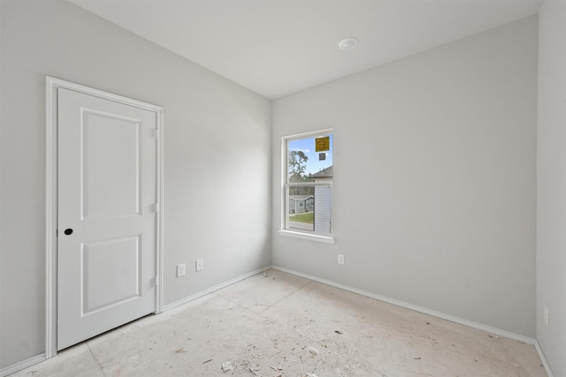 spare room with baseboards