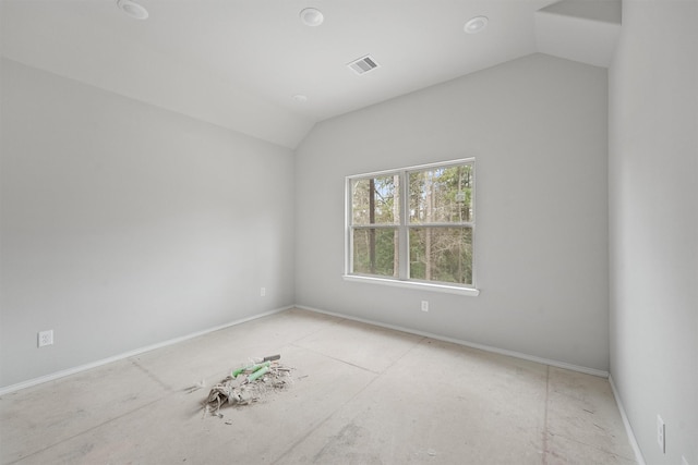 empty room with lofted ceiling and visible vents