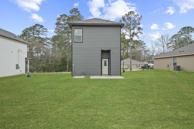 rear view of house featuring a lawn, a patio area, and central air condition unit