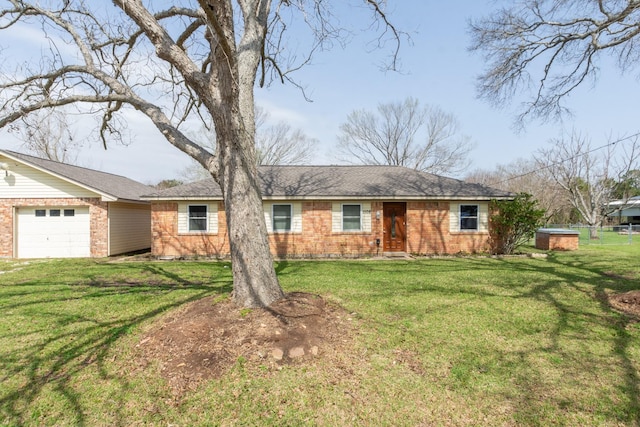 ranch-style home featuring a garage, a front lawn, and brick siding