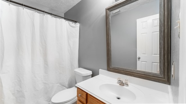 full bathroom with visible vents, a shower with shower curtain, toilet, a textured ceiling, and vanity