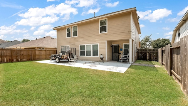 back of property featuring a yard, a patio area, a fenced backyard, and a gate