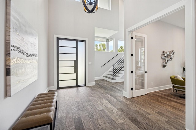 foyer featuring stairway, baseboards, and wood finished floors