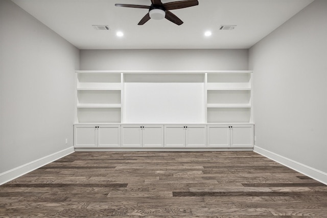 interior space featuring dark wood-style floors, visible vents, and baseboards