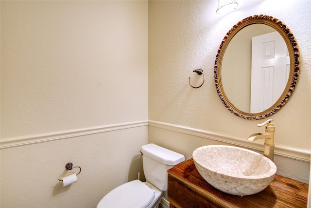 bathroom featuring toilet and vanity